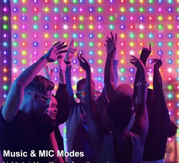 People dancing under colorful curtain lights